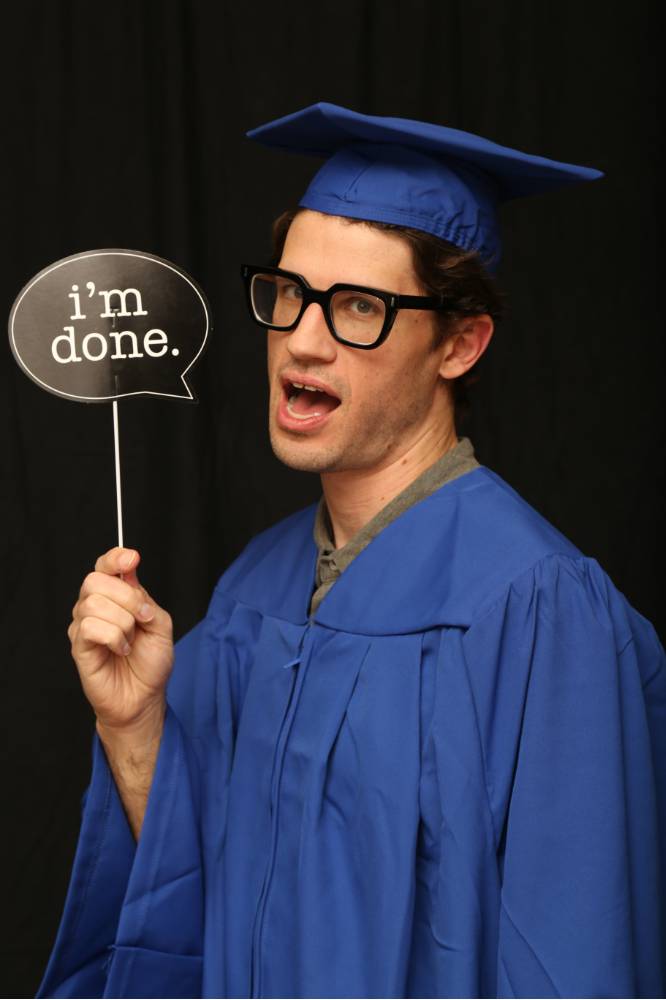 student uses 'im done' prop at GradFest photo booth